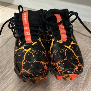 Under Armour Black and Orange Cleats with Lava Pattern
